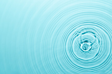 Defocus blurred blue color water ripple surface clear calm texture background with splashing...