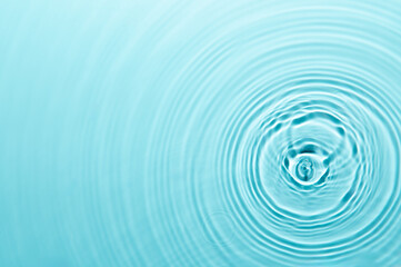 Defocus blurred blue color water ripple surface clear calm texture background with splashing bubbles water drop. Abstract and nature concept. Shiny water wave sunlight reflection shining copy space.