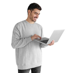 Portrait of young man in gray sweatshirt looking at laptop screen with happy smile