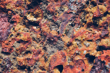 Grey, Abstract background of the shabby concrete wall surface with bright red yellow paint and mossy weathered parts