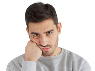 Close-up photo of young handsome man pressing hand to chin, looking bored, exhausted and...