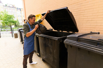 Waiter or kitchen worker responsibly disposing of garbage in pocket and placing it in city trash...