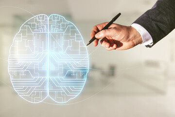 Man hand with pen working with virtual creative artificial Intelligence hologram with human brain sketch on blurred office background. Double exposure