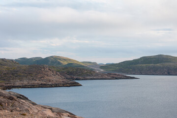 Fototapeta premium Northern mountains, the sea and mountain cold lakes on the Kola peninsula. Teriberka village