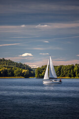 Sailboat on Lake Ukiel in Olsztyn. In the background isthmus "Snapdragon".