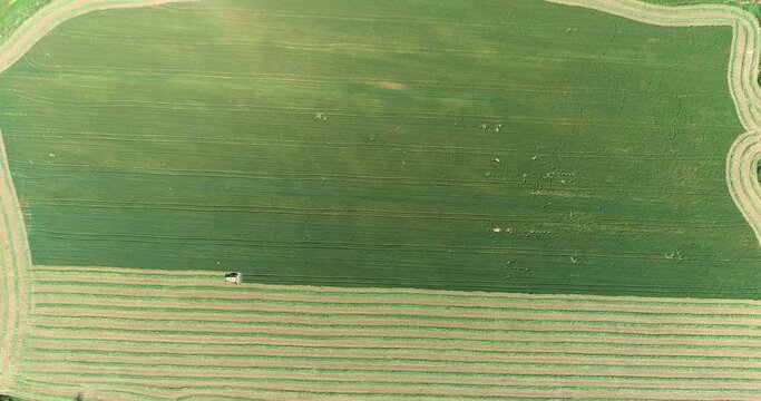 Aerial view of a agricultural machinery at action in a wheat field, Kibbutz Saar, Israel.