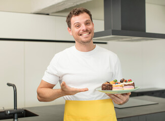 smiling cheerfully, feeling happy and showing a concept. home made cakes concept