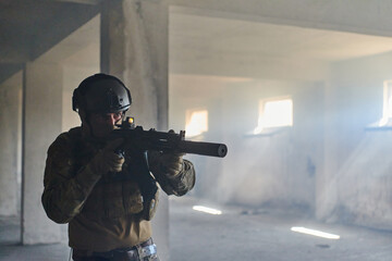 A professional soldier in an abandoned building shows courage and determination in a war campaign