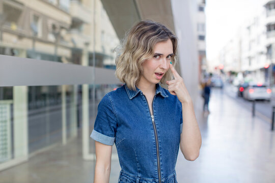 pretty woman keeping an eye on you, not trusting, watching and staying alert and vigilant