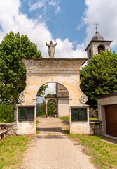 Fototapeta na wymiar Entrance arch to the ancient parish church of San Martino in the park of Oleggio Castello, province of Novara, Piedmont, Italy
