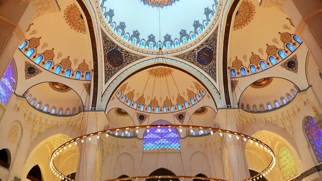 Interior view of the Camlica Mosque in Istanbul, Turkey. A lot of illumination, painted ceiling