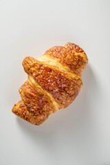 Fresh croissant over white background. Top view.