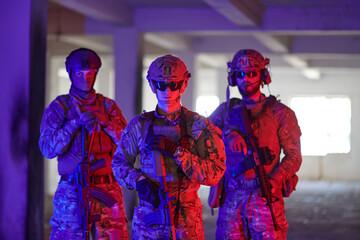 Soldier squad team walking in urban environment colored lightis