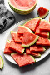 Juicy watermelon slices in a plate, top view. Summer fresh fruit snack.