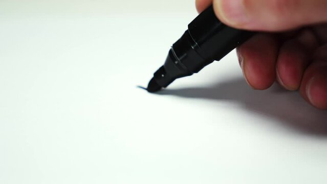 Artist drawing line with permanent marker tracking shot Close-up.
 