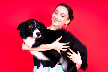 Woman walking and getting exercise for both herself and her border collie dog.