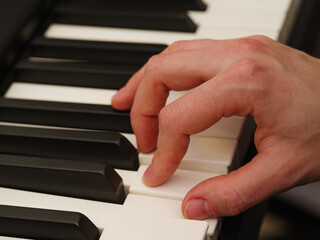 Close-up. Musician's hand on the piano keyboard. Composer, musician, singer, arranger. Recording studio, music school.