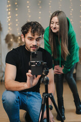 Lovely man and girl doing a live streaming while dancing online popular dances.