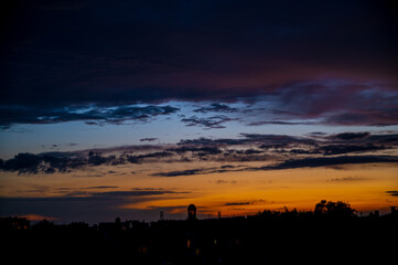 Fiery and colorful sunset clouds over the old European city center