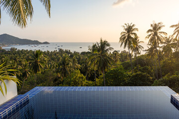 Sea view pool villa on paradise tropical Koh Tao island with beautiful exotic landscape with palms and sea horizon in sunset. Relaxing and recreation