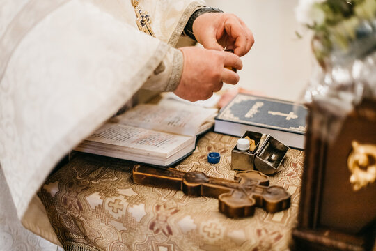 father holding holy water
