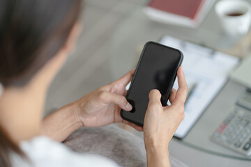 Woman hand using smartphone for checking social media or  woman reading ebook on screen.