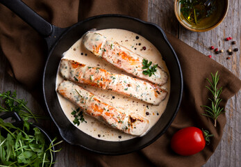 Cooked salmon fish with cream sauce in frying pan