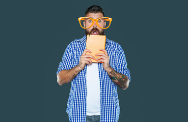 shocked funny bearded man in party glasses hold book