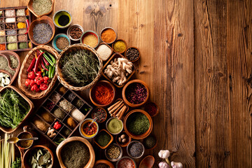 Obraz na płótnie Canvas Spices. Collection of spices in bowls on wooden rustic table forming an abstract background.