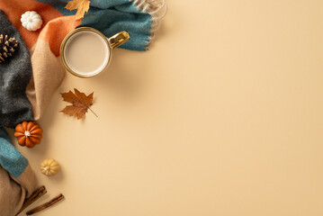 Embrace autumnal charm: top view featuring cup of fresh coffee, soft plaid, small pumpkins, yellow maple leaves, pine cone, cinnamon sticks, on tranquil beige backdrop. Ample space for text or adverts