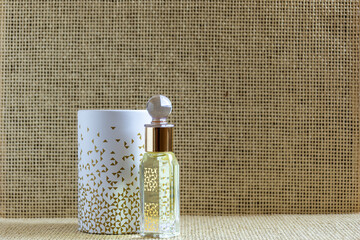 Musk perfume oil mini bottle isolated on beige background. - obrazy, fototapety, plakaty