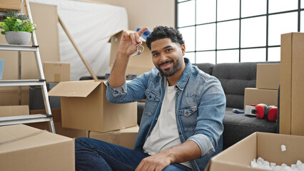 African american man smiling confident holding new house keys at new home