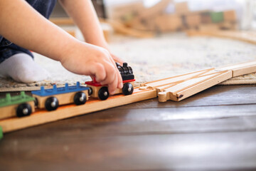 Close-up of children's hands playing with trains. The kid spends time playing. 