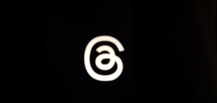 Threads logo isolated on black background.Instagram threads new social media platform app logo icon wallpaper background image