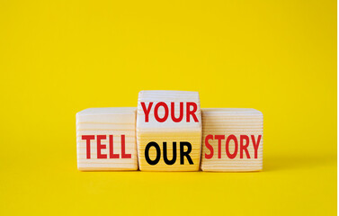 Tell Your or Our story symbol. Wooden cubes with words Tell Our story and Tell Your story. Beautiful yellow background. Business concept. Copy space
