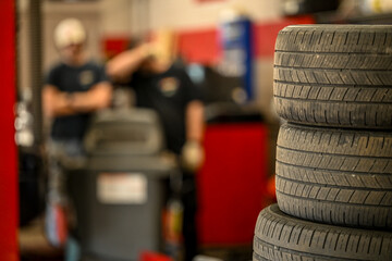 Naklejka na ściany i meble stack of used tires at automotive repair shop 