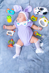 Baby boy in bunny costume,Cute baby Easter bunny. Little baby boy with bunny ears and Easter eggs in wicker basket in white fur. Symbol of Easter holiday, birth, spring, religion.