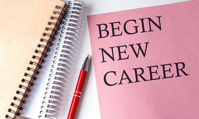 BEGIN NEW CAREER word on the pink paper with office tools on white background