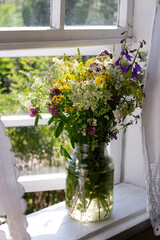 Wild flowers on window sill in countryside