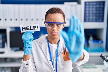 Beautiful african american woman working at scientist laboratory asking for help with open hand doing stop sign with serious and confident expression, defense gesture