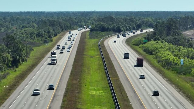 View from above of american wide freeway in Sarasota county, Florida with dense traffic of driving cars during rush hour. USA transportation infrastructure concept