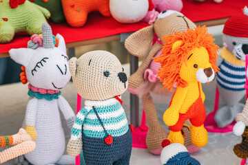 Various knitted funny toys for children are sold at the hand made market