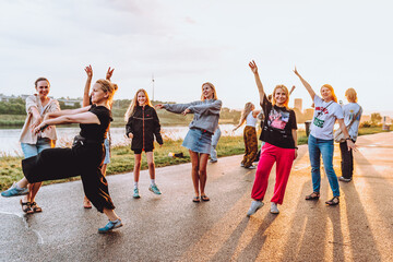 Obraz premium dancing cheerful attractive women at sunset. 