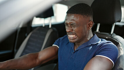Fototapeta na wymiar African american man stressed driving car at street
