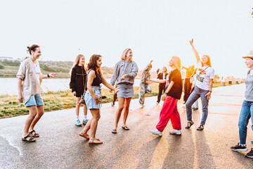 Obraz premium dancing cheerful attractive women at sunset. 