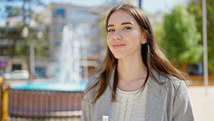 Young hispanic woman smiling confident at park