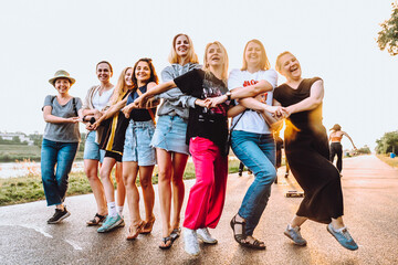 Obraz premium dancing cheerful attractive women at sunset. 