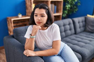 Obraz premium Young woman stressed sitting on sofa at home