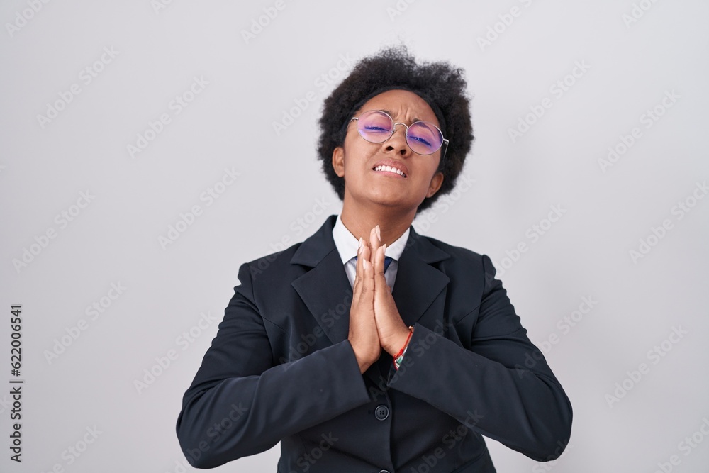 Sticker beautiful african woman with curly hair wearing business jacket and glasses begging and praying with