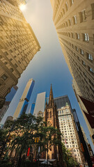 Looking up into the sky between two buildings in New York City